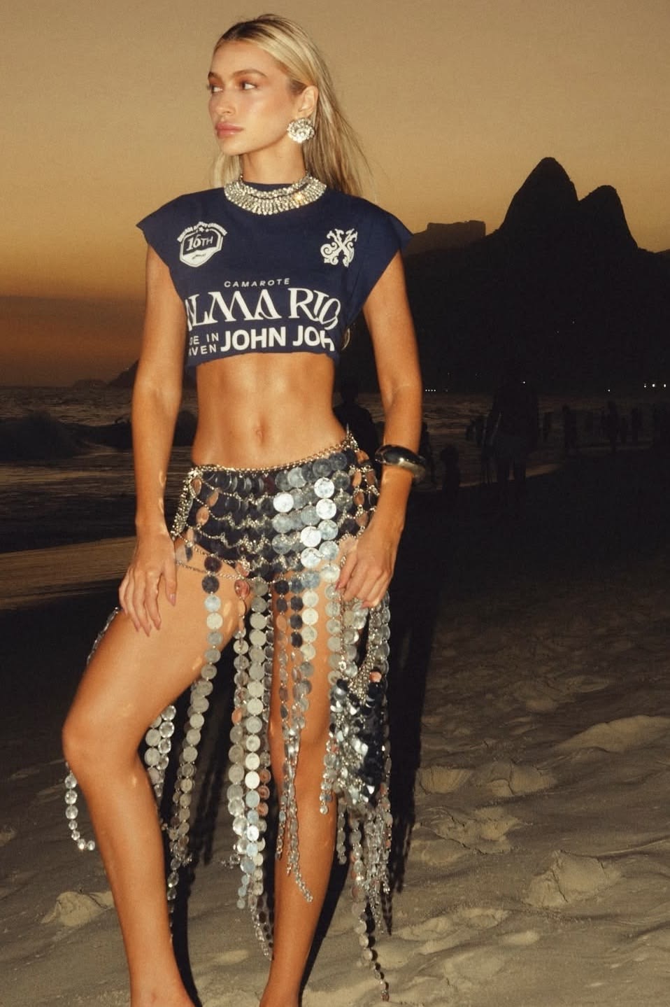Cropped official shirt paired with a metallic festival skirt