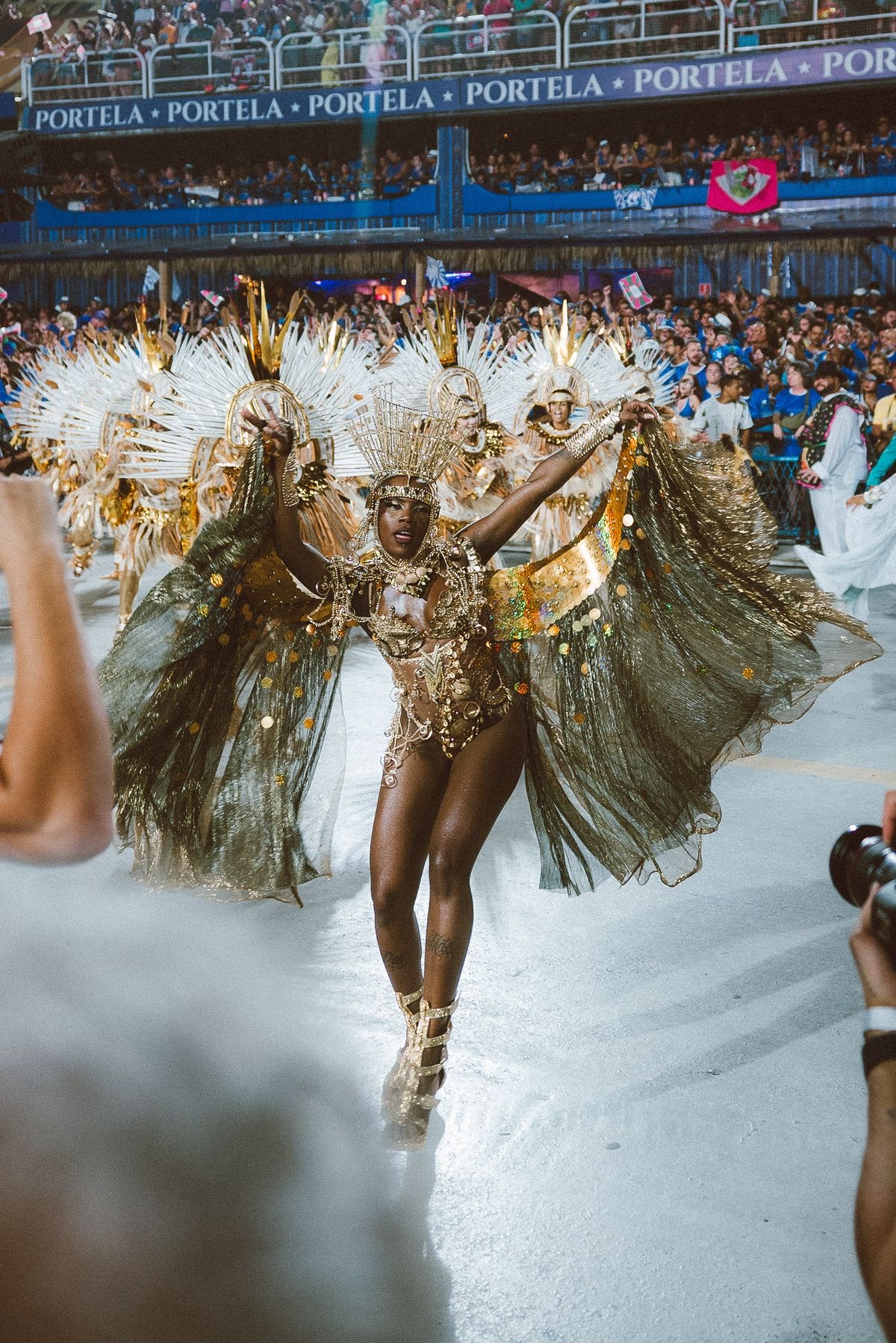 Samba performer with the Sambadrome crowd behind her